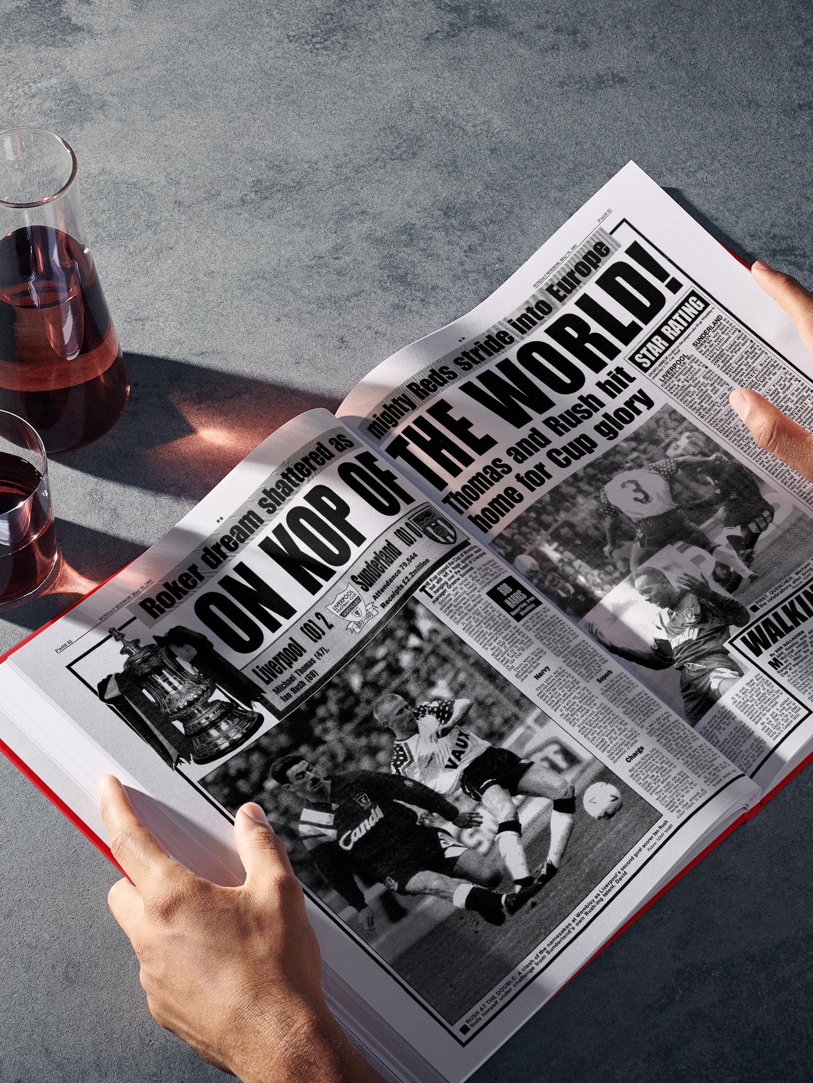 Open spread of the Liverpool Football History book by Historic Newspapers, featuring red-themed pages and historical football images.